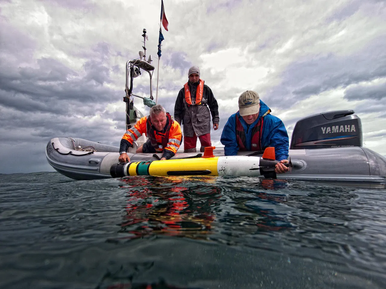 NineNorth field team deploying an AUV from a vessel in the open ocean